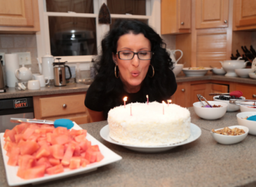 Vegan Birthday Cake - Anna Szabo is blowing off cake candles at her 37th Birthday